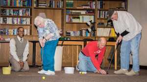 St. Monica's Senior Residents enjoying putting indoors.